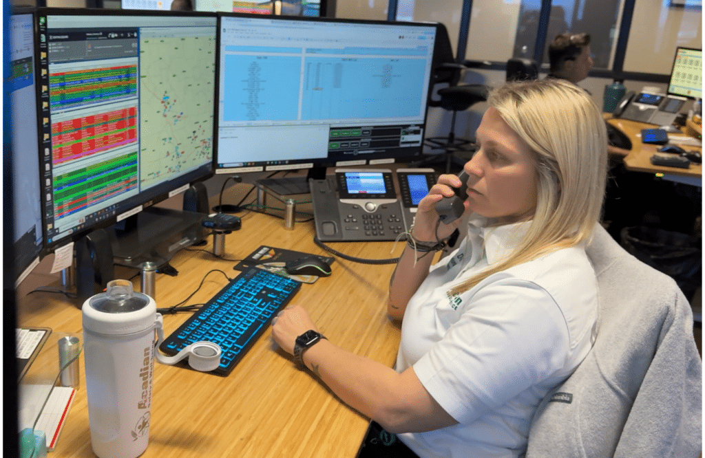 Air Med Communications Air Med Operations Coordinator Courtney D. speaks on the phone while seated at her work station.