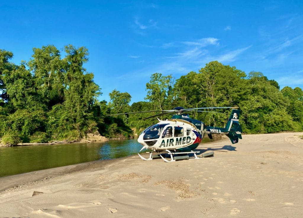 airmed helicopter on river bank