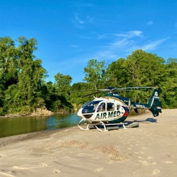 airmed helicopter on river bank